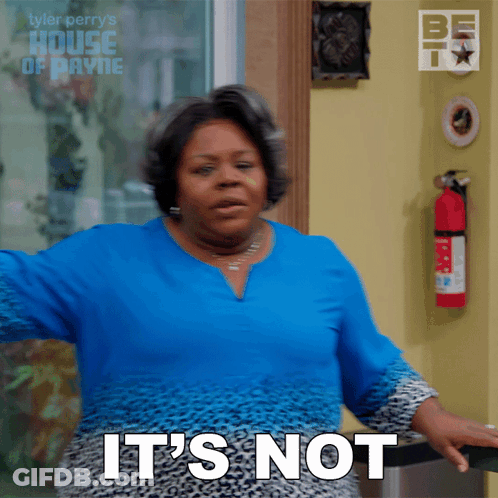 A Woman Says It 'S Not While Standing In Front Of A Fire Extinguisher GIF
