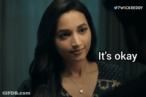 A Woman Says " It 'S Okay " In Front Of A Blue Background GIF