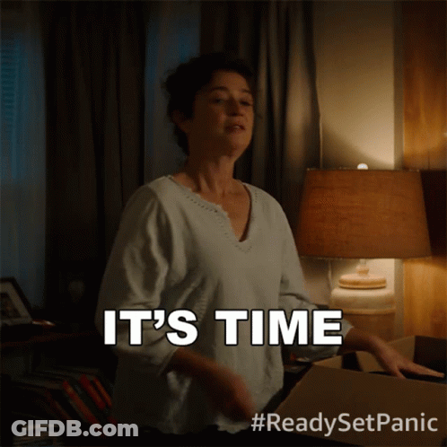 A Woman Says It 'S Time While Standing Next To A Lamp GIF