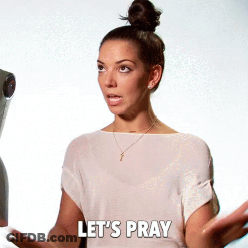 A Woman Says Let 'S Pray While Standing In Front Of A Camera GIF