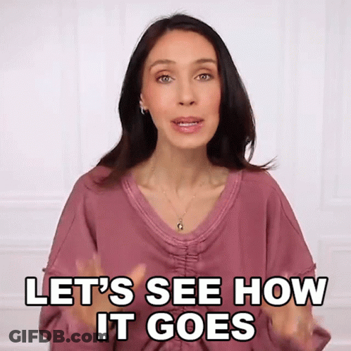 A Woman Says Let 'S See How It Goes With Her Hands In The Air GIF
