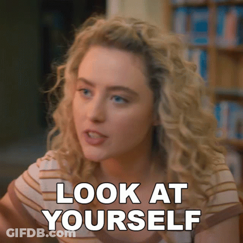 A Woman Says Look At Yourself In Front Of A Bookcase GIF