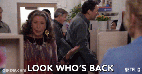 A Woman Says Look Who 'S Back While A Man Looks On GIF