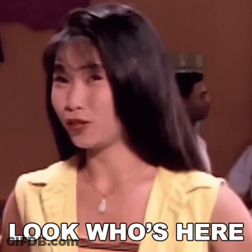 A Woman Says Look Who 'S Here While Looking At The Camera GIF