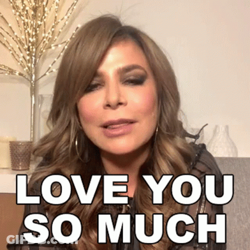 A Woman Says " Love You So Much " In Front Of A Vase GIF