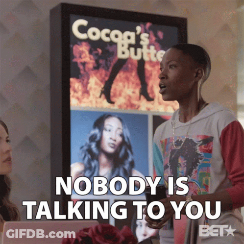 A Woman Says Nobody Is Talking To You In Front Of A Cocoa 'S Butter Sign GIF