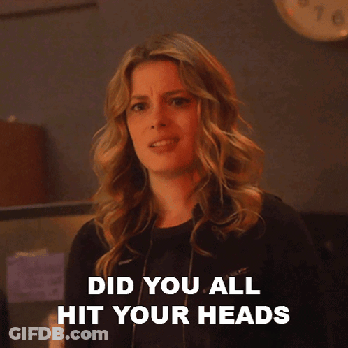 A Woman Says On Each Other 'S Heads While Looking At The Camera GIF