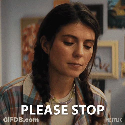 A Woman Says Please Stop In Front Of A Netflix Sign GIF