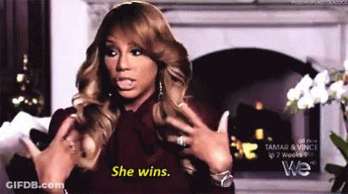 A Woman Says She Wins In Front Of A Fireplace . GIF