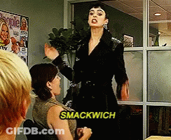 A Woman Says Smackwich While Standing In Front Of A Group Of People GIF