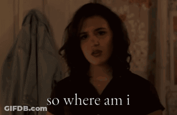 A Woman Says " So Where Am I " While Standing In Front Of A Wall GIF