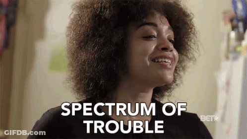 A Woman Says Spectrum Of Trouble In Front Of A Bet Logo GIF