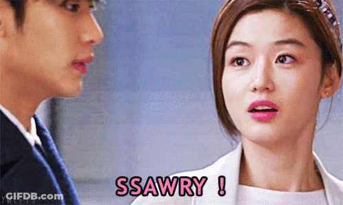A Woman Says Ssawry While Looking At A Man In A Suit GIF