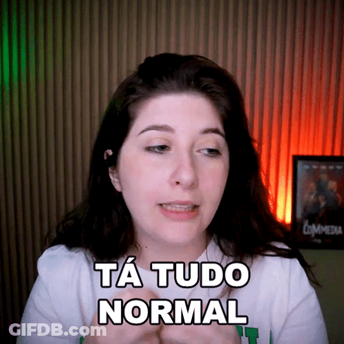 A Woman Says Ta Tudo Normal In Front Of A Commedia Poster GIF