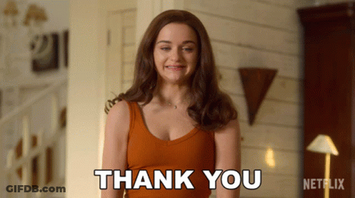 A Woman Says Thank You In Front Of A Netflix Sign GIF