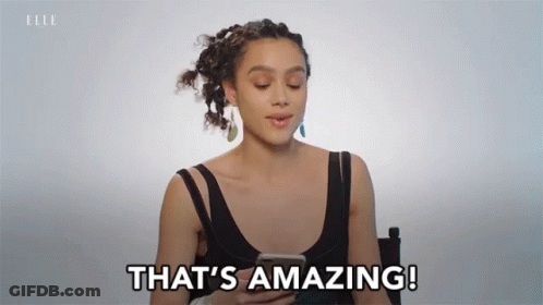 A Woman Says That 'S Amazing While Holding A Cell Phone GIF
