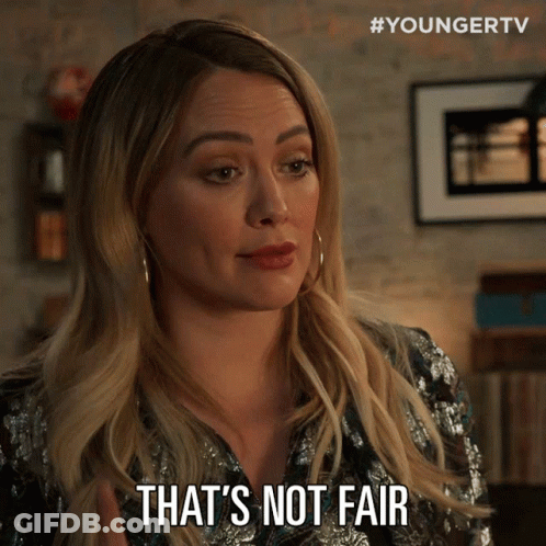 A Woman Says " That 'S Not Fair " While Wearing A Sequined Shirt GIF