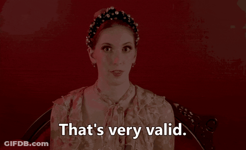 A Woman Says That 'S Very Valid In Front Of A Red Wall GIF