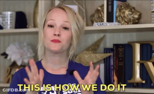 A Woman Says " This Is How We Do It " In Front Of A Bookshelf GIF