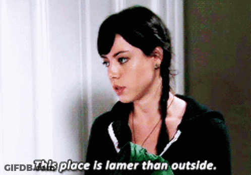 A Woman Says " This Place Is Lamer Than Outside " In Front Of A Wall GIF