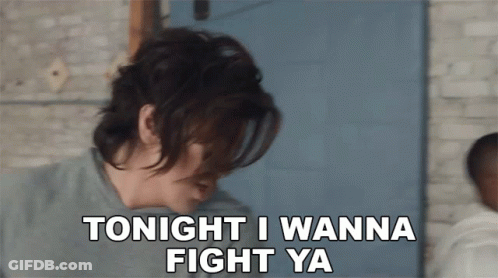 A Woman Says " Tonight I Wanna Fight Ya " In Front Of A Blue Door GIF