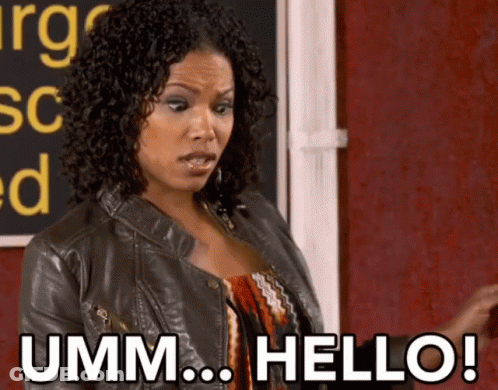 A Woman Says " Umm Hello " In Front Of A Blackboard GIF