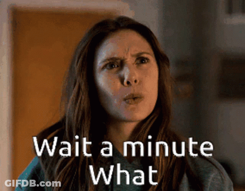 A Woman Says Wait A Minute What In Front Of A Door . GIF