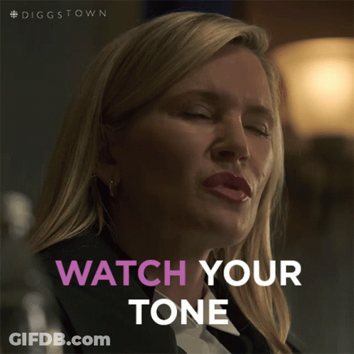 A Woman Says Watch Your Tone While Looking Down At Something GIF