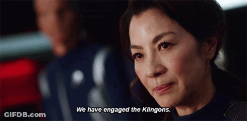 A Woman Says " We Have Engaged The Klingons " In Front Of A Man GIF