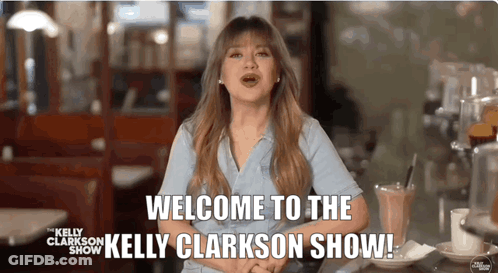 A Woman Says Welcome To The Kelly Clarkson Show While Sitting At A Table GIF