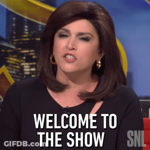 A Woman Says Welcome To The Show On A Snl Sign GIF