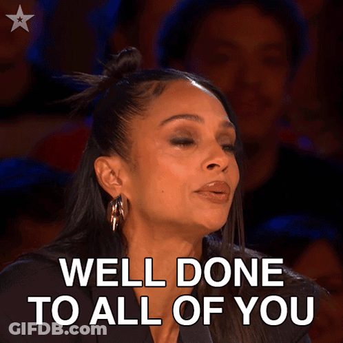 A Woman Says Well Done To All Of You In A Crowded Room GIF