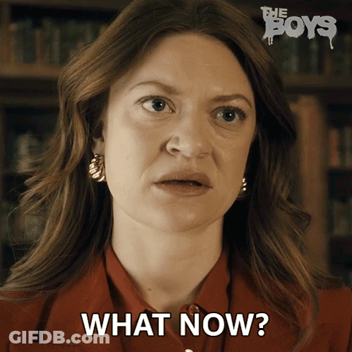 A Woman Says What Now In Front Of A Poster For The Boys GIF