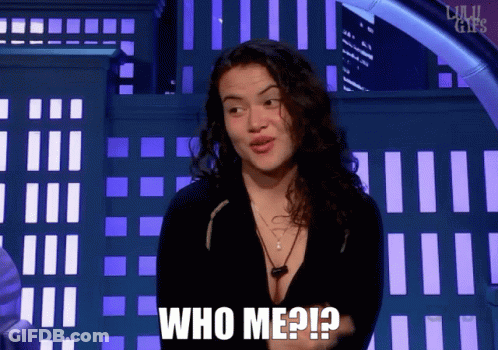 A Woman Says " Who Me ? " In Front Of A Building GIF
