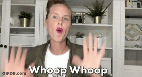 A Woman Says Whoop Whoop In Front Of A Bookshelf GIF