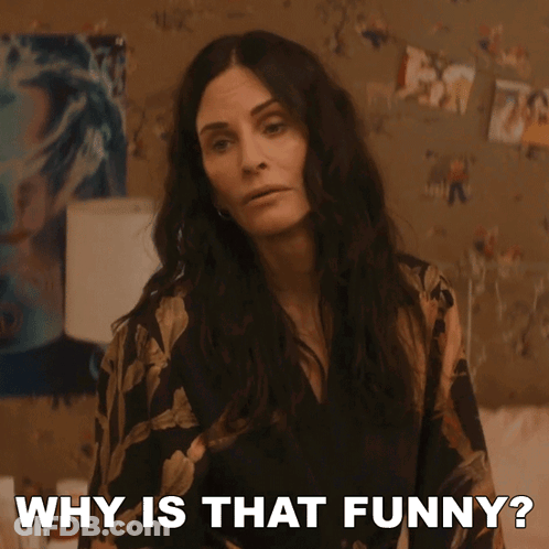 A Woman Says Why Is That Funny In Front Of A Wall Of Pictures GIF