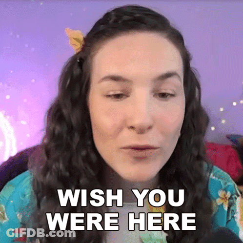 A Woman Says Wish You Were Here In Front Of A Purple Background . GIF