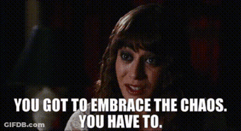 A Woman Says " You Got To Embrace The Chaos You Have To " In A Dark Room GIF
