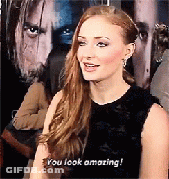A Woman Says " You Look Amazing " In Front Of A Man 'S Face GIF