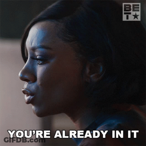 A Woman Says " You 'Re Already In It " In Front Of A Bet Logo GIF