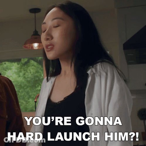 A Woman Says " You 'Re Gonna Hard Launch Him " In A Kitchen GIF
