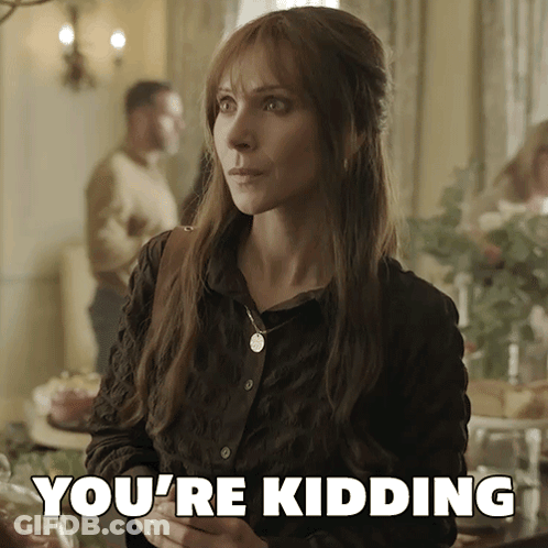 A Woman Says You 'Re Kidding While Standing In Front Of A Table GIF