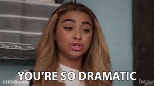 A Woman Says " You 'Re So Dramatic " In Front Of A Rack GIF