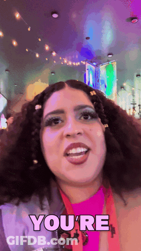 A Woman Says " You 'Re " While Smiling GIF