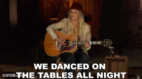 A Woman Singing And Playing A Guitar With The Words We Danced On The Tables All Night GIF