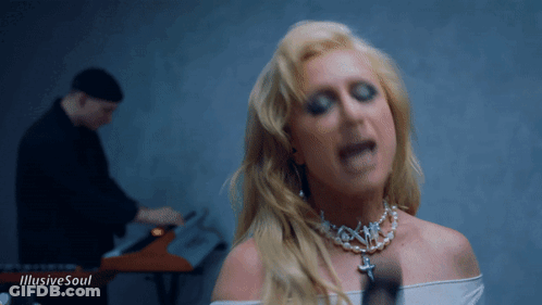 A Woman Singing In Front Of A Man Playing A Keyboard With The Words " Illusive Soul " On The Bottom GIF