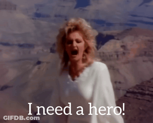 A Woman Singing In Front Of A Mountain With The Words I Need A Hero GIF