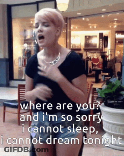 A Woman Singing In Front Of A Store That Says ' Where Are You ' GIF