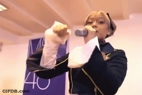 Woman Singing Into Microphone With 40 Sign GIF