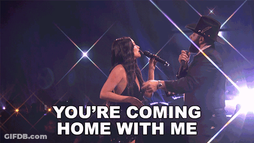 A Woman Singing Into A Microphone Next To A Man With The Words " You 'Re Coming Home With Me " On The Bottom GIF